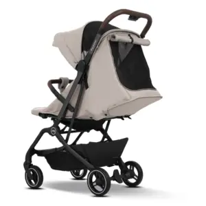 Beige baby stroller with a black frame and brown handle, shown at an angle with a storage basket underneath and a mesh window on the canopy.