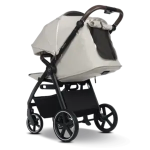 Baby stroller with a beige canopy and brown leather handle on a black frame and large wheels, showing its bassinet setup and storage basket underneath.
