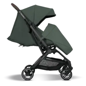 Green baby stroller in profile with a large canopy and brown handle, black frame, and storage basket underneath.