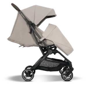 Beige baby stroller with an oversized canopy, black frame, and four small wheels in a compact, ready-to-use stance.