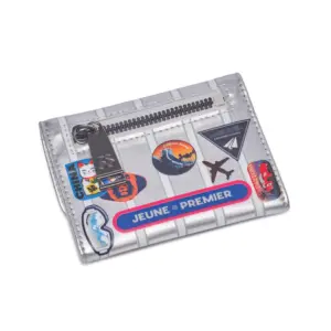 Silver wallet with a zipper and colorful travel-themed stickers laid flat on a white background