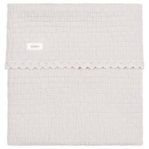 Cream textured towel with a decorative lace trim across the middle and a small Koeka label, folded flat.