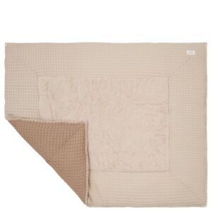 Beige textured throw blanket with a folded corner showing a tan underside.