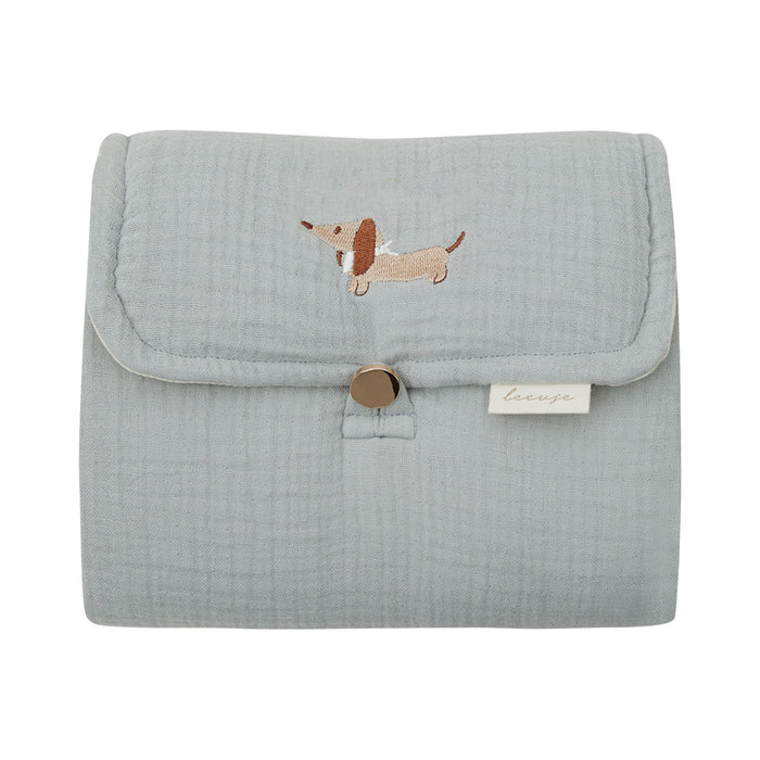 square_image5 Light blue fabric cosmetic pouch with a dachshund embroidery and a snap button closure, plus a small brand tag.