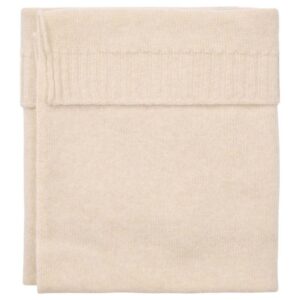 Cream knitted blanket folded neatly for display