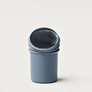 Blue cylindrical trash can with a plastic liner visible inside the open top