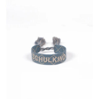 Blue woven bracelet with white embroidery forming a geometric pattern and the word SHULKND, with two tassels at ends.
