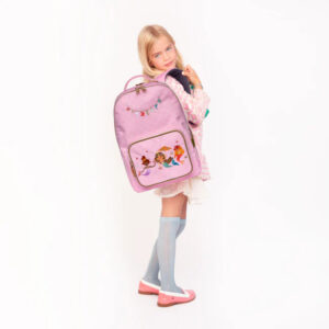 Little girl wearing a pink cartoon backpack, standing against a white background with one shoulder turned toward the camera.