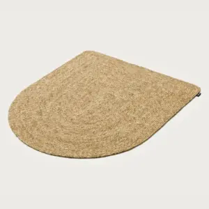 Natural fiber door mat in a rounded teardrop shape with a natural beige color
