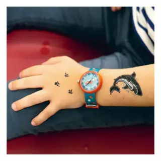 Child's hand with tiny paw-print tattoos, a blue star-pattern watch on the wrist, and a dolphin tattoo on the forearm.